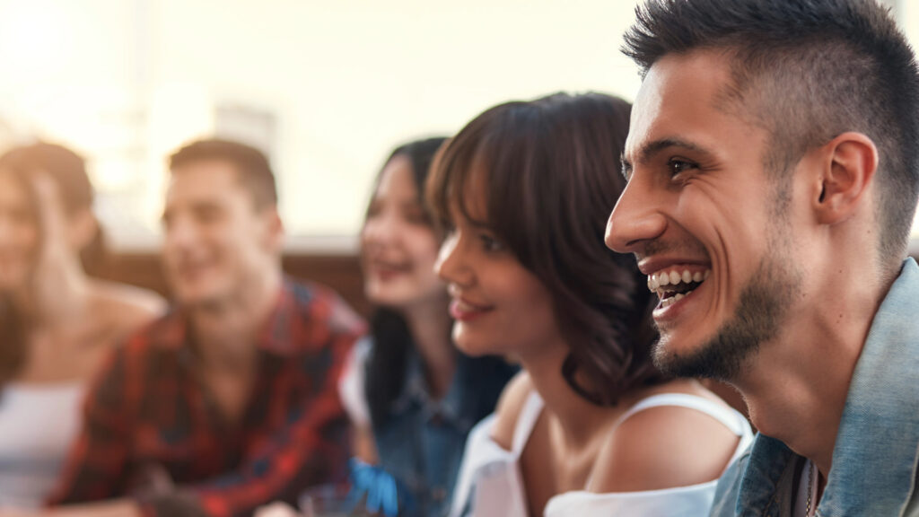 Close-up of a group of friends laughing and smiling, enjoying time together.