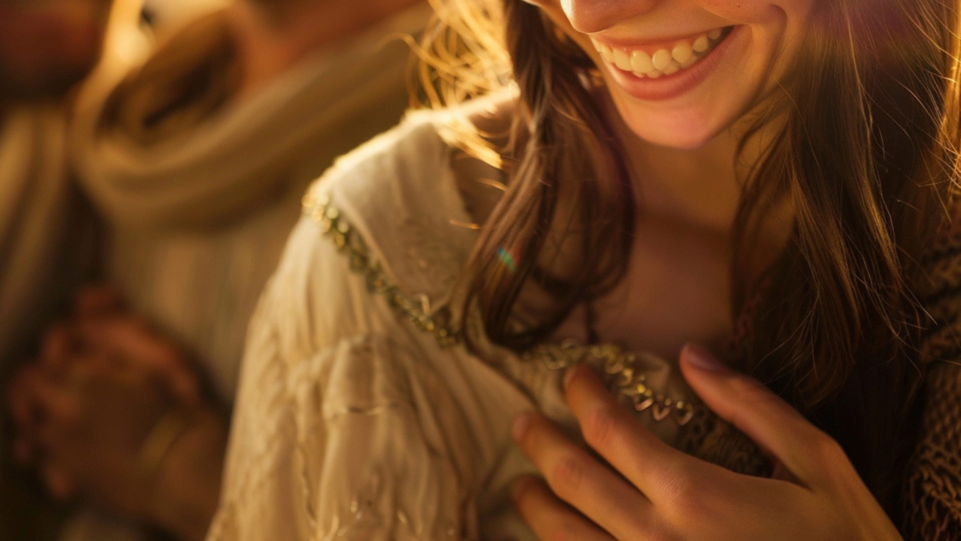 Woman smiling with her hand on her chest, dressed in an embroidered blouse, illuminated by warm, gentle lighting, conveying a sense of joy and serenity.