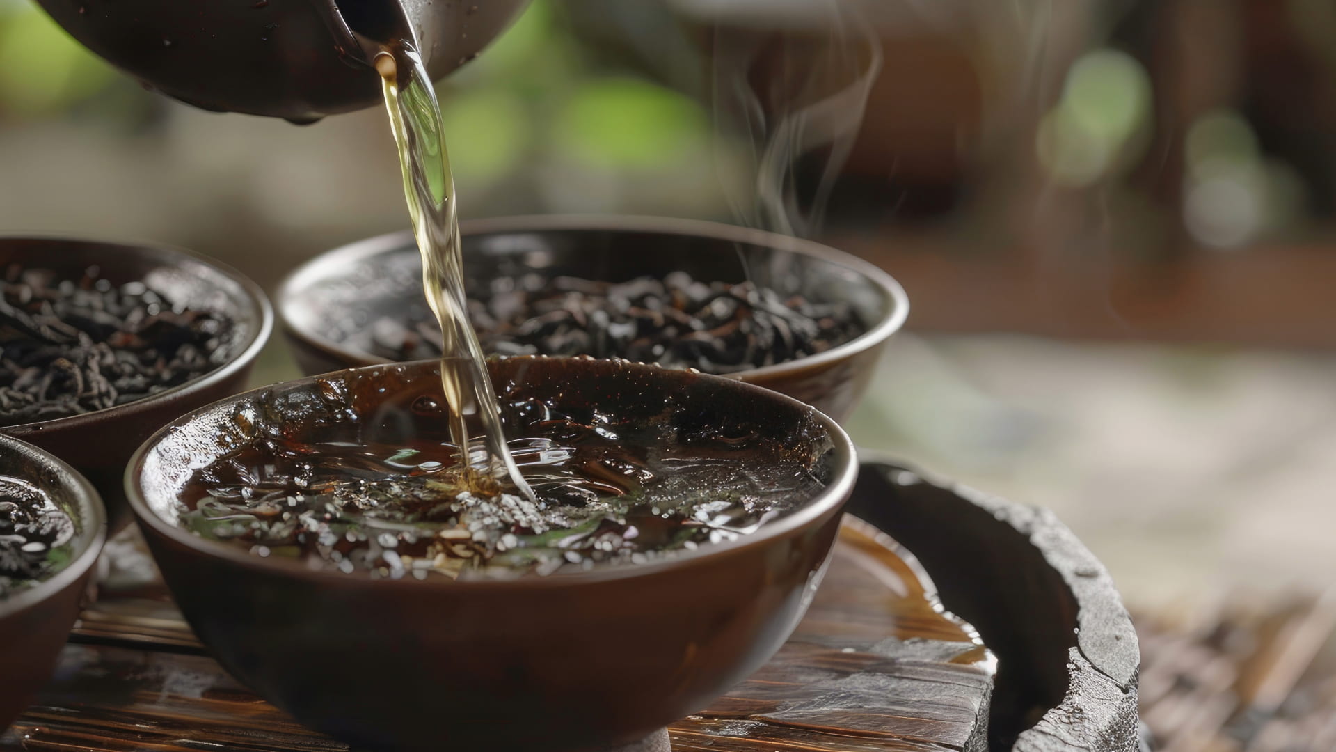 Herbal tea being poured into a steaming bowl, with dried herbs in the background, evoking a sense of relaxation and warmth in a traditional setting.